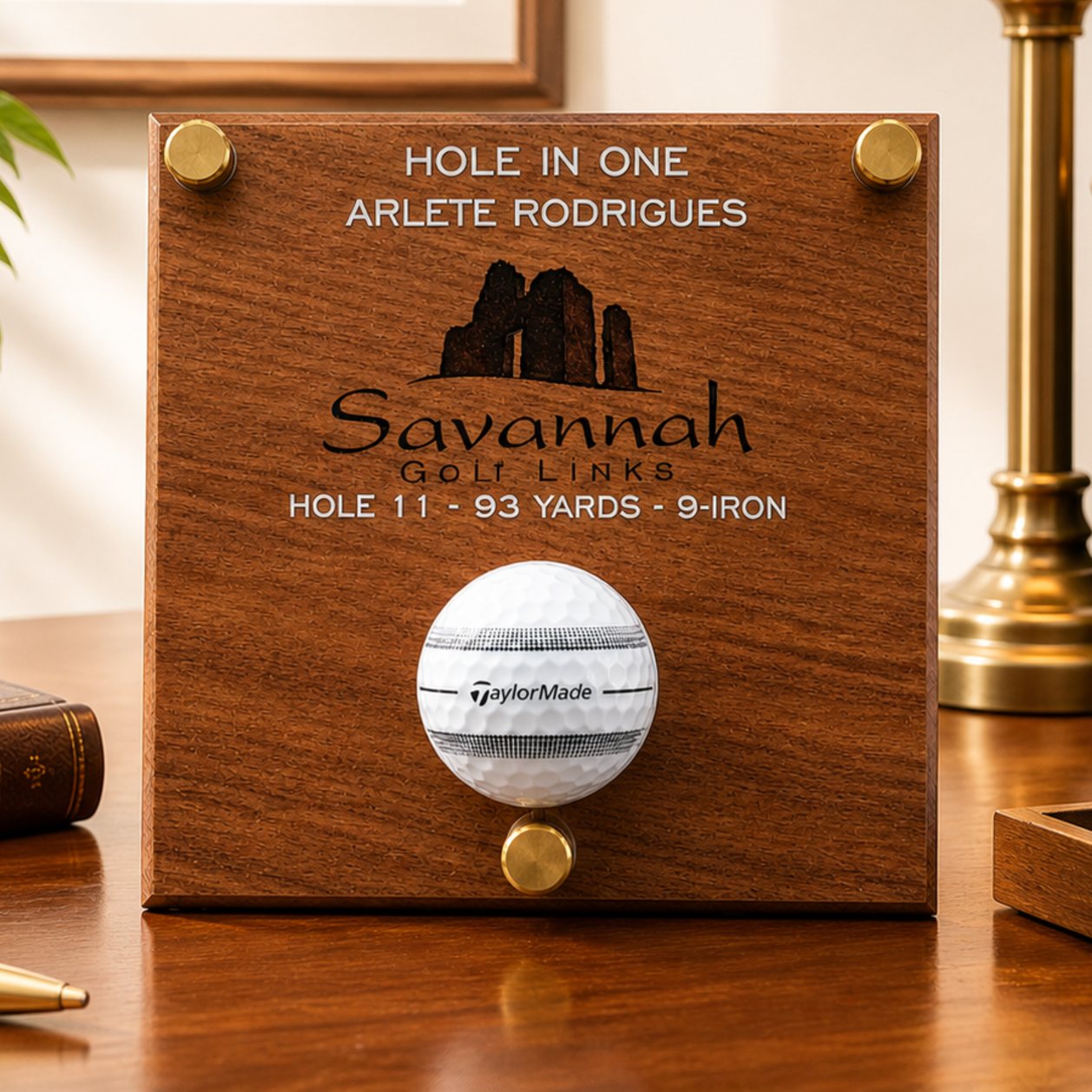 Hole in one ball holder etched on wood.